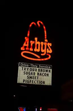 A sign advertising inclusion of highly processed meat and added sugar in a sandwich