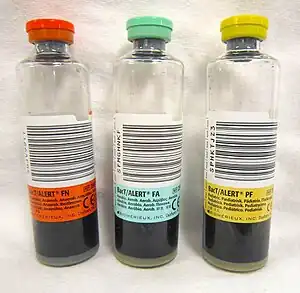 Three clear bottles with differently coloured caps and labels.