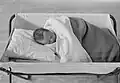 An infant sleeping in 1940. The use of pillows and blankets is no longer recommended as these can inadvertently cause suffocation.