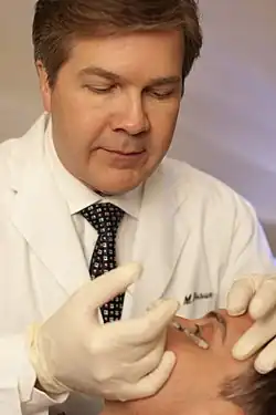 Botulinum toxin being injected in the face