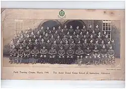 Formal picture of approx 50 males in Army Uniform, front row seated, with the officers,  then 4 rows standing probably on benches or staging, about 15 per row, presumably of dentists who were passing out following completion of the course