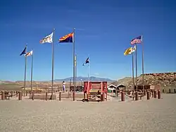 A photograph of the Four Corners Monument, at the spot where the borders of Arizona, Colorado, New Mexico, and Utah meet each other