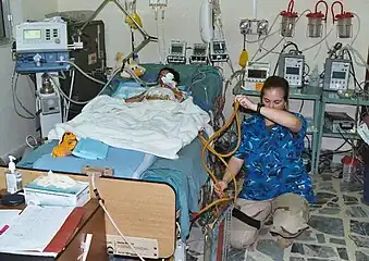 US Army ICU nurse attending to a patient in Baghdad, Iraq