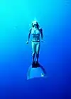Woman freediving with a monofin