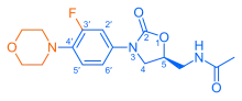 Skeletal formula of N-{[(5S)-3-[3-fluoro-4-(morpholin-4-yl)phenyl]-2-oxo-1,3-oxazolidin-5-yl]methyl}acetamide, highlighting the morpholino and fluoro groups in orange, with the rest in blue. The carbon atoms of the parent chain are numbered.