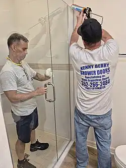 Worker installing a glass door