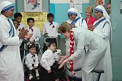 The First lady of USA, Ms. Laura Bush interacting with the disabled children on her visit to Mother Teresa Light of Life Home (Jeevan Jyothi) for disabled children, in New Delhi on 2 March 2006.
