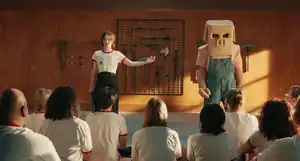 Natalie at the front of the classroom with a person dressed up as a Piglin.