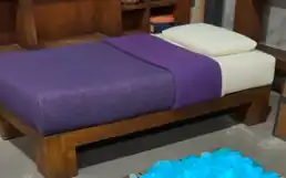 A purple bed depicted in A Minecraft Movie.