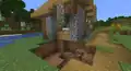 A creeper explosion that damaged a village house.