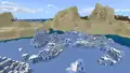 A frozen ocean next to desert hills in Bedrock Edition. Note the ocean ruins in an iceberg.