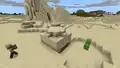 A desert pyramid in desert hills in Bedrock Edition.