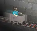 Action figure of Steve riding a minecart.