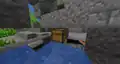 A chest located in an ocean ruins building, that is hidden by a block, viewed in spectator mode.