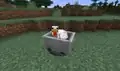 A chicken riding a minecart.