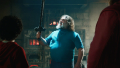 Steve holding up a freshly-crafted Iron Sword in A Minecraft Movie.