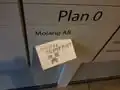 Mojang building directory board with a note from some griefers.[56]
