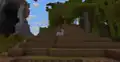 Zuri riding a pig while the pig is riding a minecart