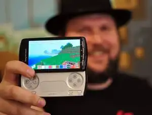 Pre-release on Xperia Play with Notch holding it and smiling.