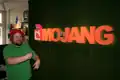 Notch in front of the Mojang sign.