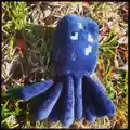 Squid plush on the ground.