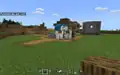 A wandering trader that spawned in a player-made village in Minecraft Education