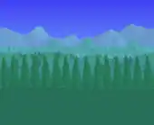 Pine trees blocking a hilly landscape.