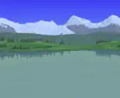 Large lake in a forest with a distant house and snowy mountains.