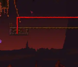 A teleporter with a Pressure Plate track above, at the end of a long rail. Red wire leads away from the image.