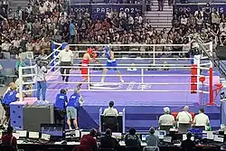 Carini and Khelif are fighting in the boxing ring.
