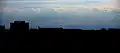 Mount Parashka (in the middle) in the background of the building of the State Tax Service. View from Lviv (90 km)