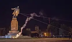 The statue in the process of being toppled