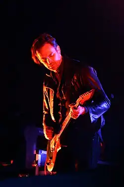 Fertita performing with Queens Of The Stone Age in 2014.