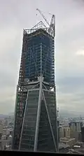 Feb 1, 2017 - Installation of roof decorative structure in progress, window glass significantly complete on office floors.