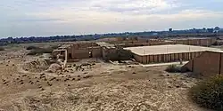 The reconstructed "platform" (right) before the axial stairway of the ziggurat. The temple complex appear