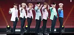 Seven boys in suits of varying color