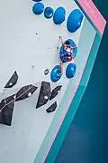 A climber doing the high-stepping technique