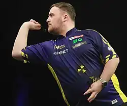 Luke Littler throwing a dart at a 2025 Premier League Darts event