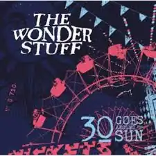 A red Ferris wheel with flags above it, in front of a dark blue skyline