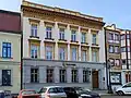 The neoclassical tenement house from the 18th century at 5 White Eagle Square, alongside Staromłyńska Street.