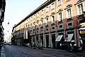 A view of the Via Manzoni, showing the Museo Poldi Pezzoli surrounded by several shops, such as the Caffe dell' Opera.