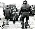 A Korean toddler climbs the boarding ramp onto a C-54 at Kimpo