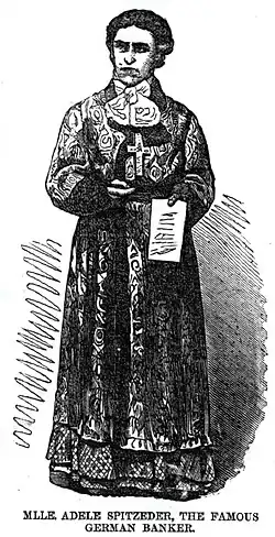 Spitzeder depicted as a stern looking woman in a full dress with a large cross on her chest and a note in her left hand.