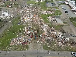 Piles of rubble that used to be houses on a street in Greenfield, Iowa
