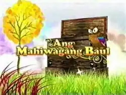 An image of an owl next to a wooden box, with grasses and a tree on the surrounding. The series title is displayed on the center of the image.