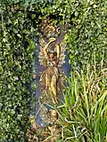 A glazed terracotta plaque approximately 40 metres (130&nbsp;ft) east of the fountain[9]