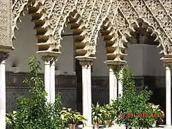 Multifoil arches in the Mudéjar Patio de las Doncellas at the Alcazar of Seville in Spain (14th century)