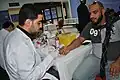 Bahrani man offering his blood for donation during Ashura