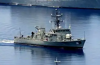 An image of a warship on water.