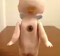 Back of bisque Kewpie, c. 1912: All official Kewpies have signature blue wings on the back of their necks.